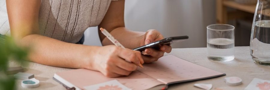 a woman writing on a piece of paper